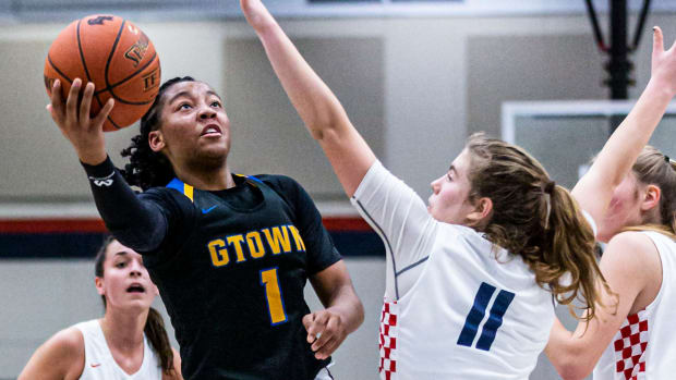 Germantown's Kamorea \"KK\" Arnold (1) shoots around Brookfield East's Annika Pluemer (11) during the game at Brookfield on Friday, Dec. 10, 2021. Wn Bke Gt Gball 2603